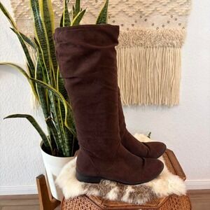 Brown suede knee high riding boots with a low heel and round toe. Size: US 6.5